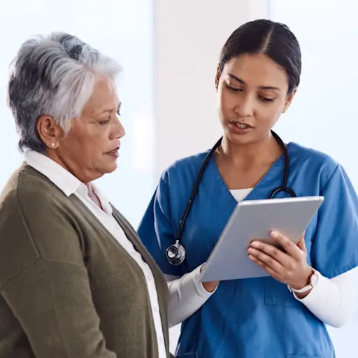 senior woman talking to nurse