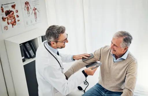 man getting blood pressure at doctor's office