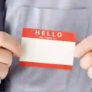 Businessman Attaching Blank Name Tag