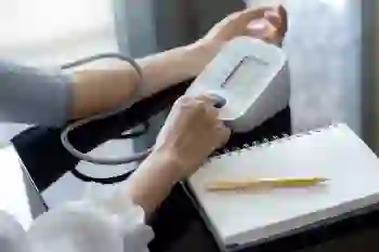 Cropped view of a person using a digital sphygmomanometer to measure their blood pressure.