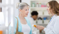 Pharmacist reminding patient of drug interactions.