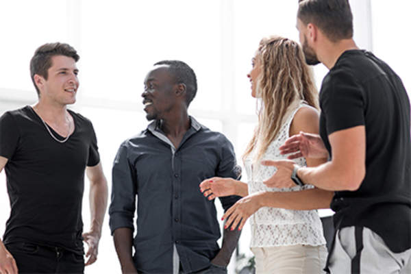 Group of young people standing and talking.