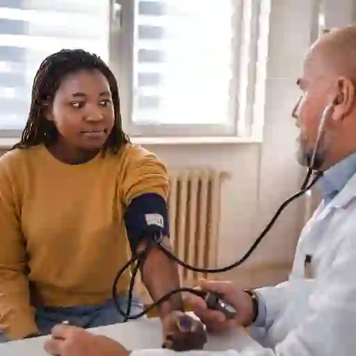 A woman gets her blood pressure taken