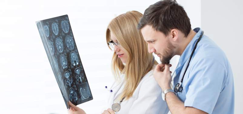 doctors looking at MRI scans