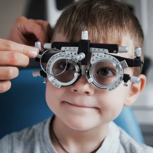 小男孩拿着荧光镜在医生的办公室里检查眼睛