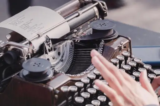 hand typing on typewriter