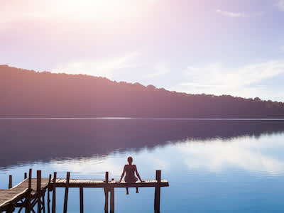 坐在码头上眺望湖面的女人。