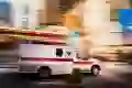 An ambulance drives down a street