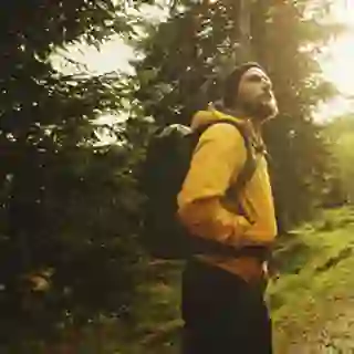 Man taking a hike in the woods.