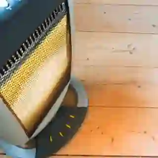 Space heater on pine floor.