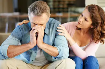 Woman comforting her husband.
