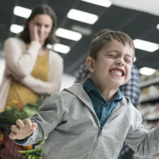 Child with dysmorphic mood dysregulation disorder having an outburst in a supermarket.