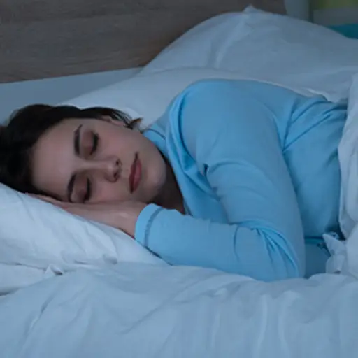 Woman sleeping in bed.