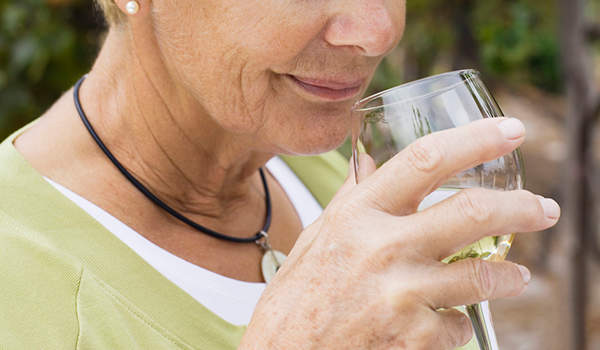 女人喝葡萄酒。