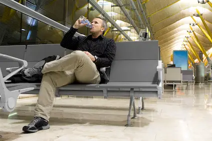 一名男子在清晨航班前喝水。