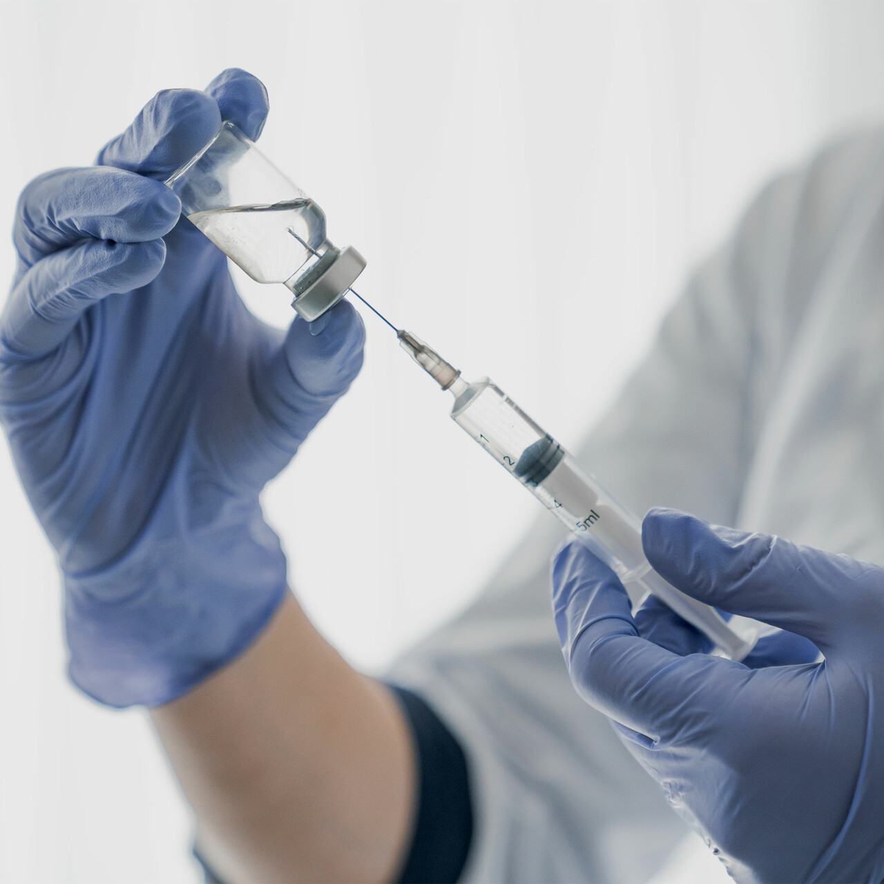 一个特写的医疗专业人员正在填充注射器