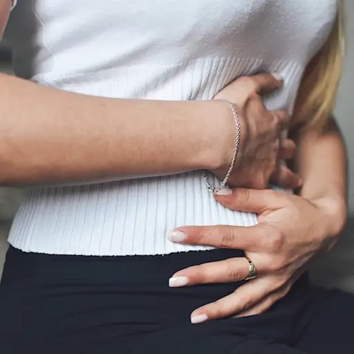Woman experiencing acid reflux pain