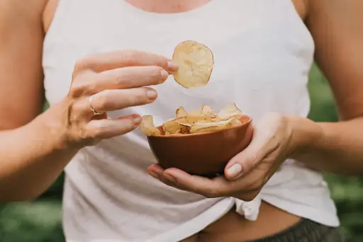 woman eating potato chips