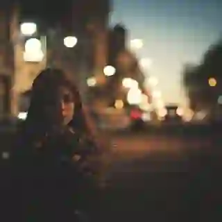 Women standing by herself in the city at night
