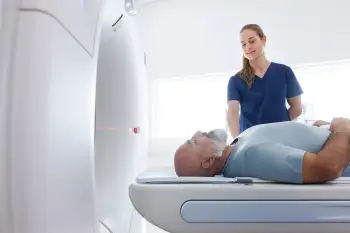 A man enters a CT scanner