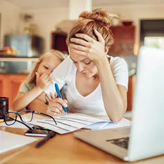 Stressed mother working at home