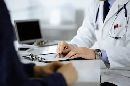 A doctor explains something to a patient