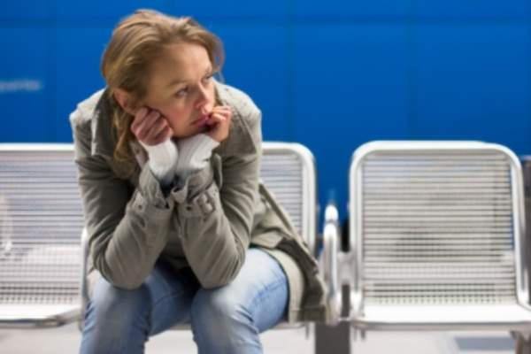 坐在车站的心烦意乱的女人