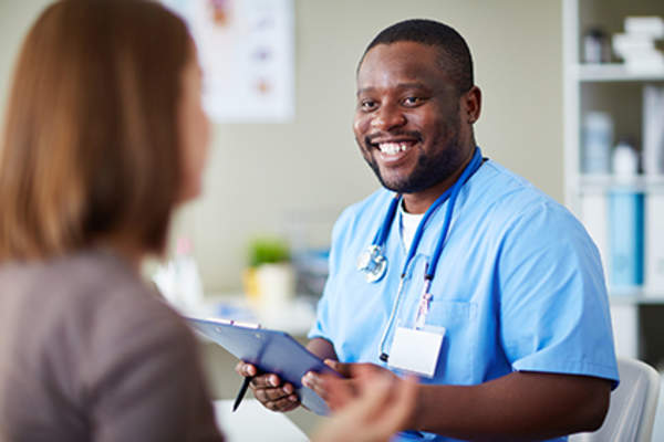 Woman talking to a nurse practitioner.