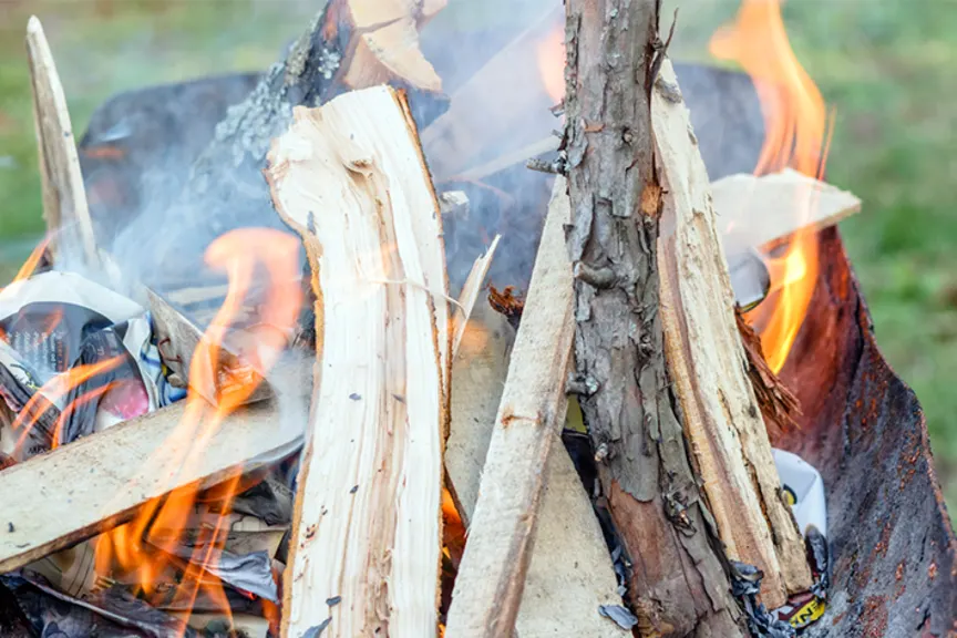 Wood smoke in outdoor fire pit.