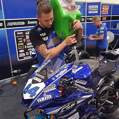 Jarie Scheepstra, owner of Volare Motoren, fills a tank of a motorcycle with gasoline.