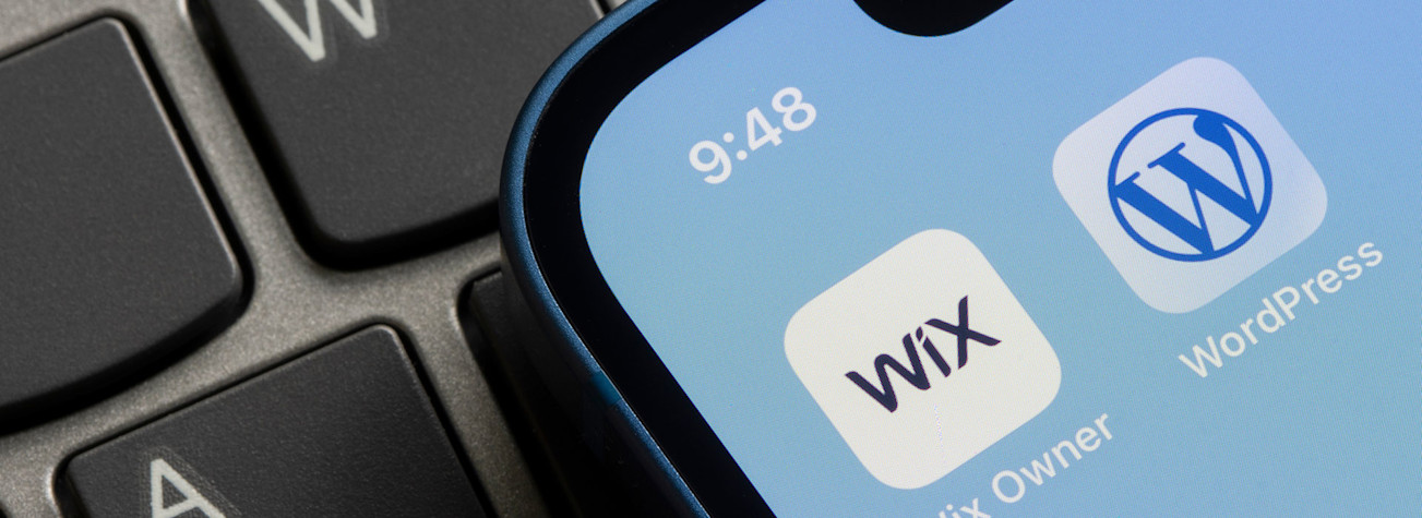 The apps 'Wix Owner' and 'WordPress' on the screen of an iPhone.