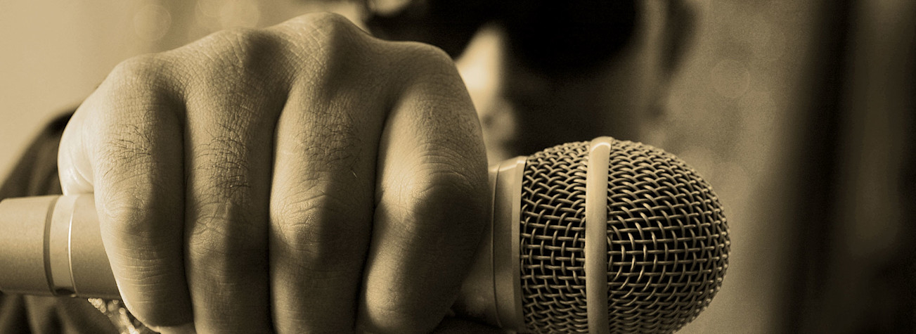 Close-up of a rapper's hand holding a microphone