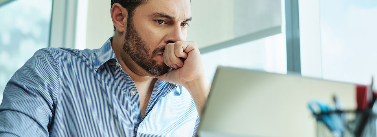 Entrepreneur looking worried at his laptop