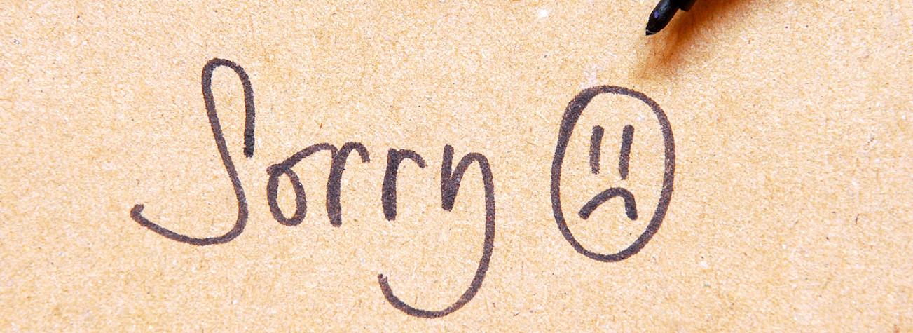 Sorry note handwritten on old paper