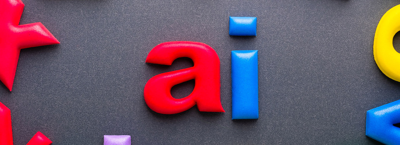 Colorful foam letters forming the word AI on dark background