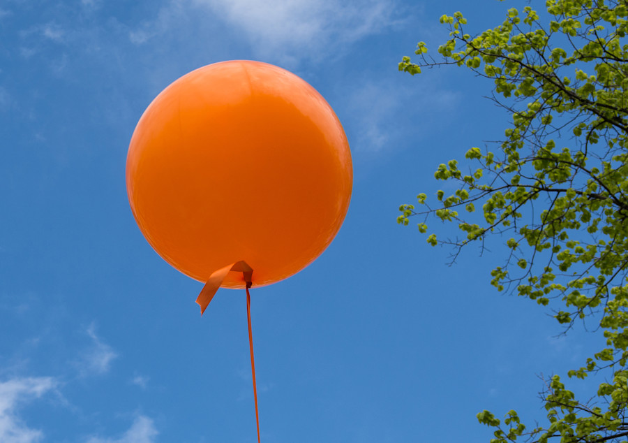 orange balloon in a clear blue sky