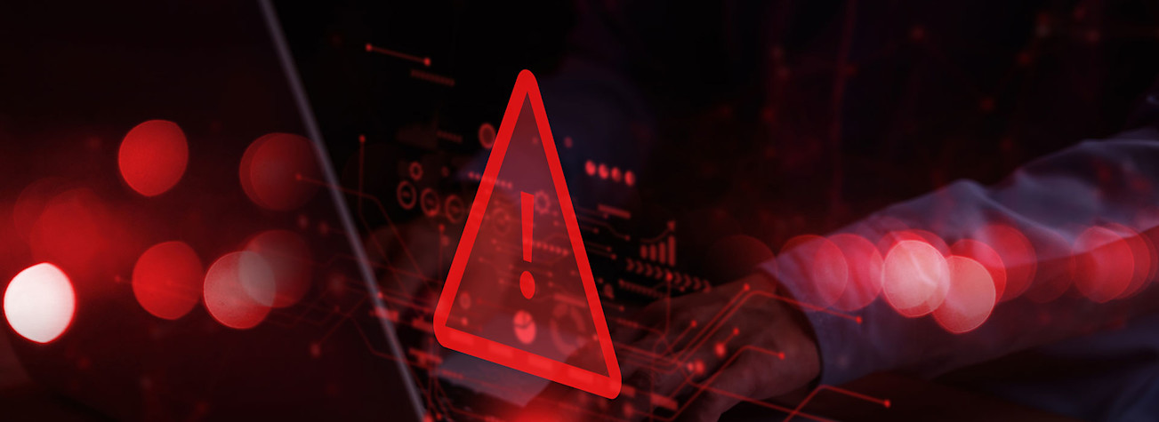 Red warning symbol above a laptop