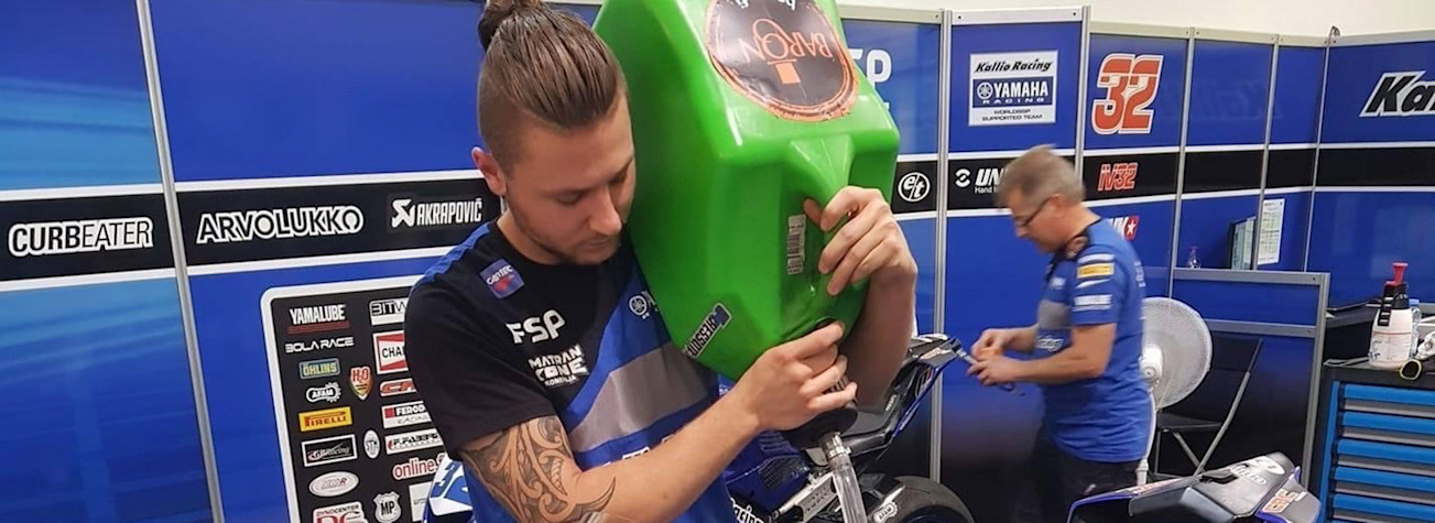 Jarie Scheepstra, owner of Volare Motoren, fills a tank of a motorcycle with gasoline.