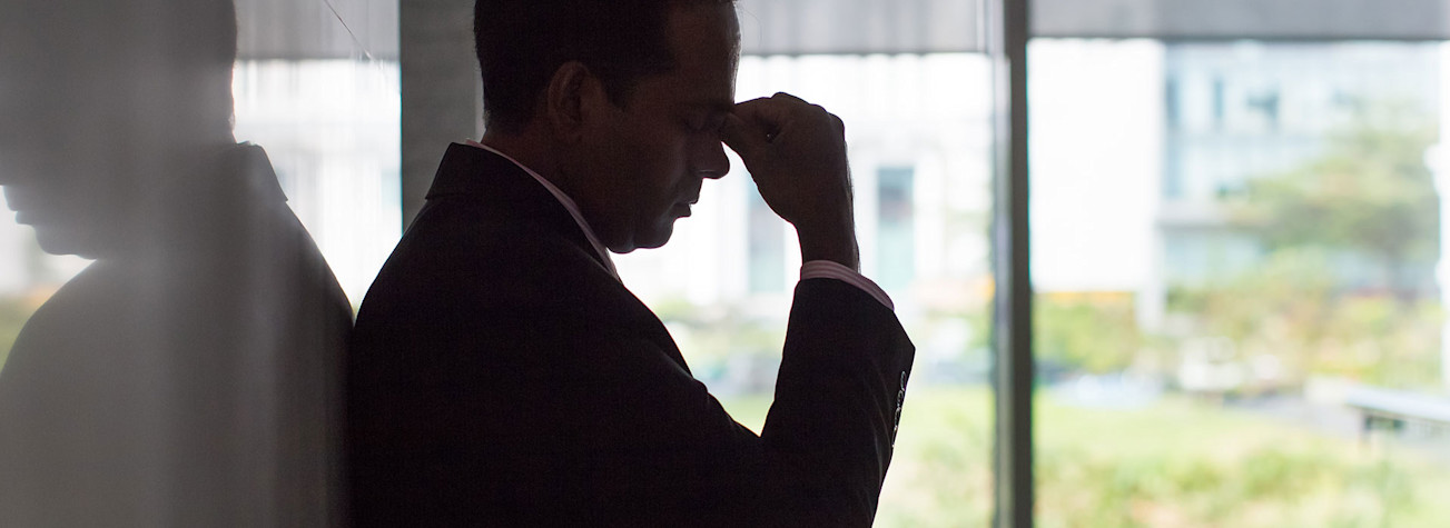 Silhouette of stressed businessman