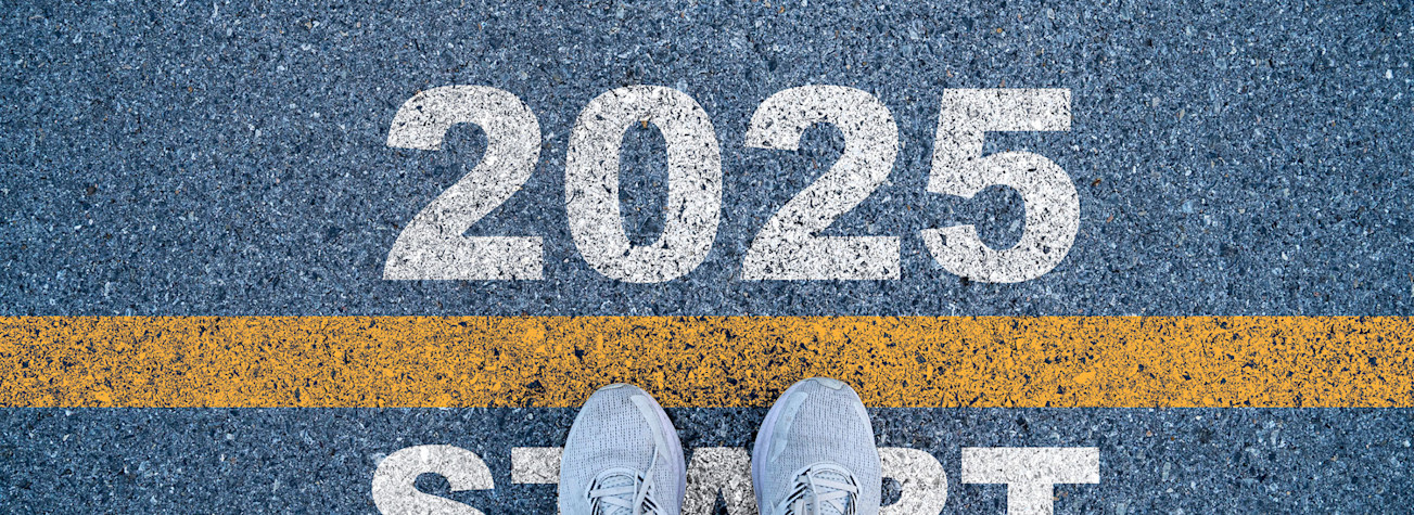 Runner at the starting line, where '2025' is written on the track.