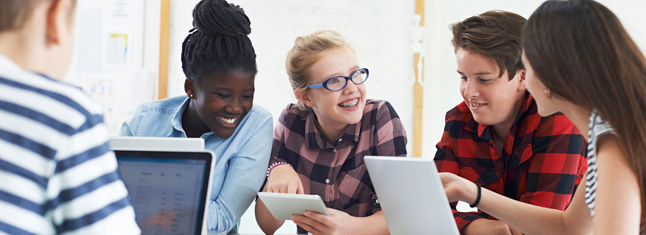 Group of teenage students working together on an IT project