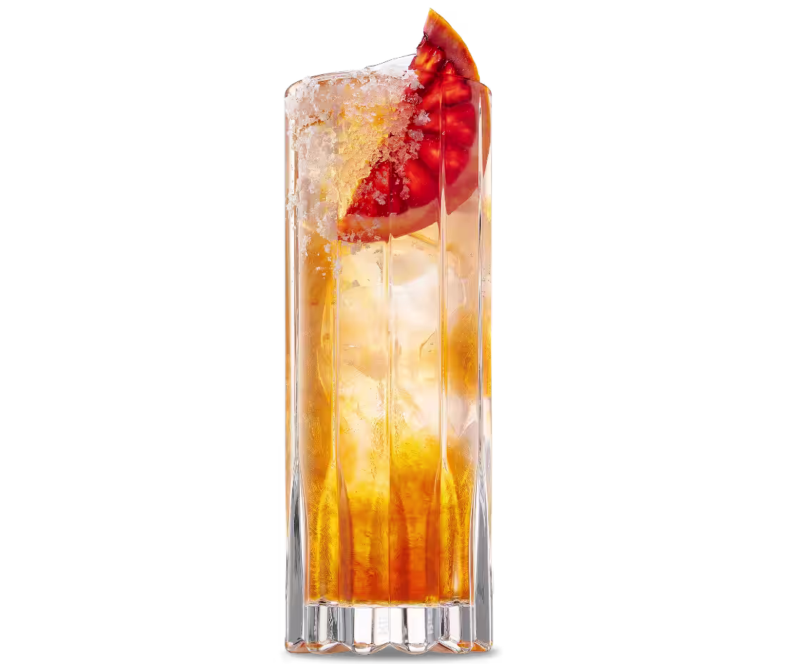 A Paloma Negra cocktail in a highball glass with a grapefruit wedge garnish.