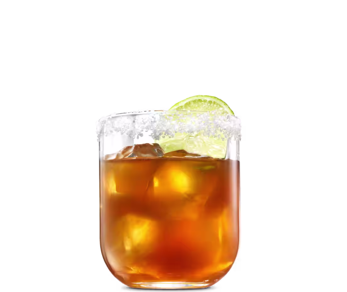 A Margarita Negra cocktail on ice in a rocks glass with a salted rim and lime wedge garnish.