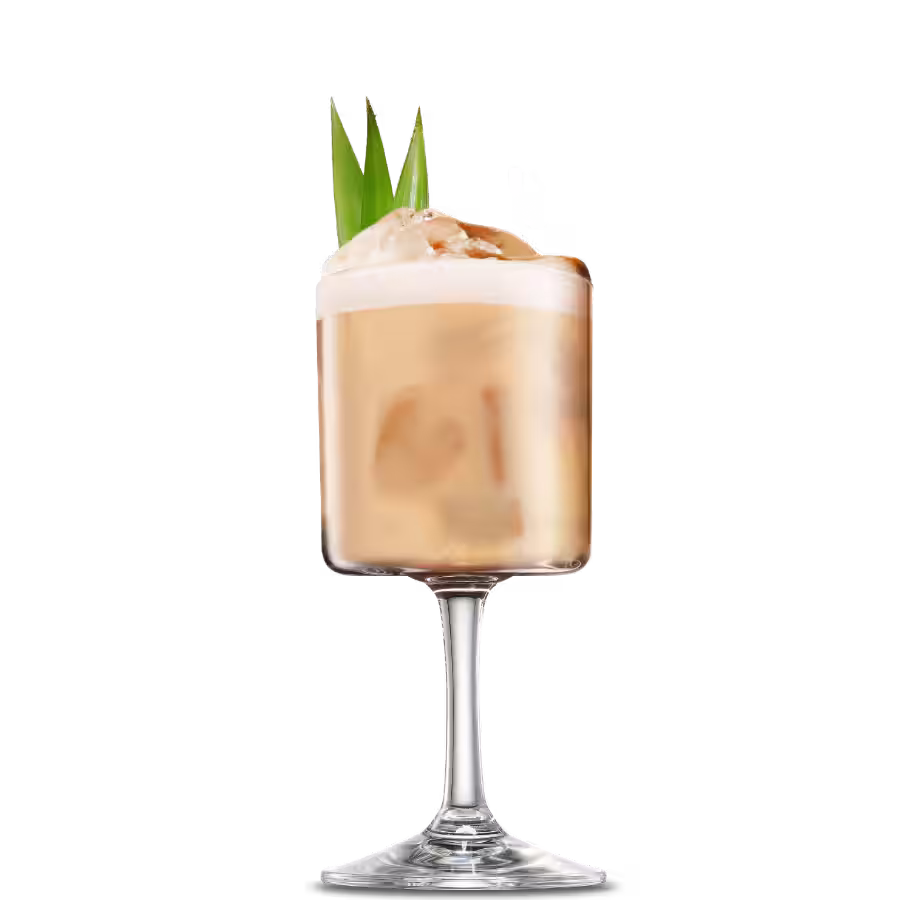 A Cafe Colada cocktail with pineapple leaves for garnish.