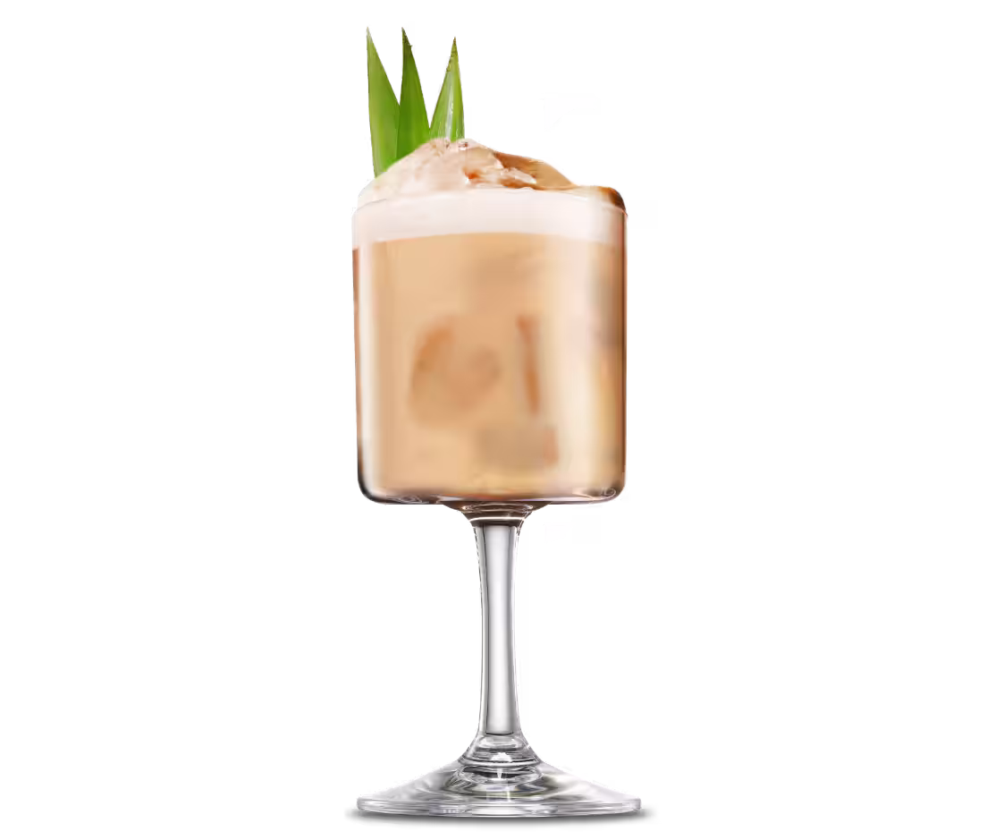 A Cafe Colada cocktail with pineapple leaves as garnish