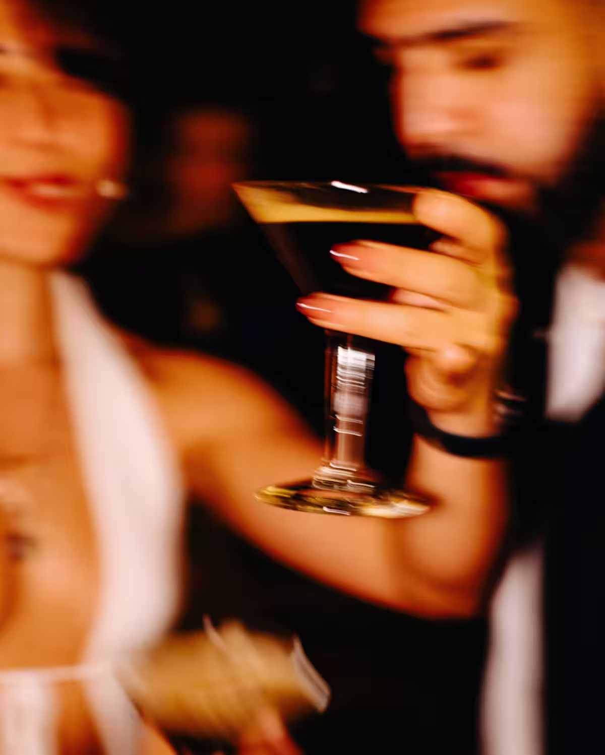 A couple dancing with an Espresso Martini in hand