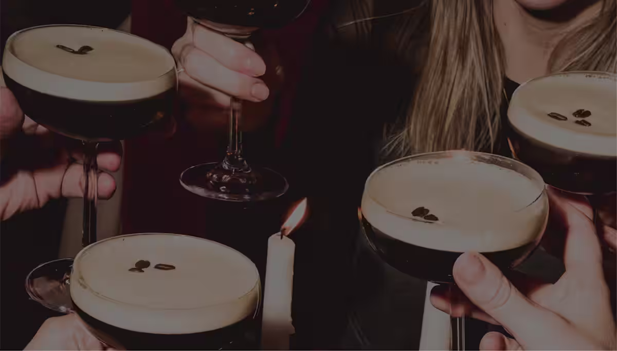 Hands holding espresso martinis