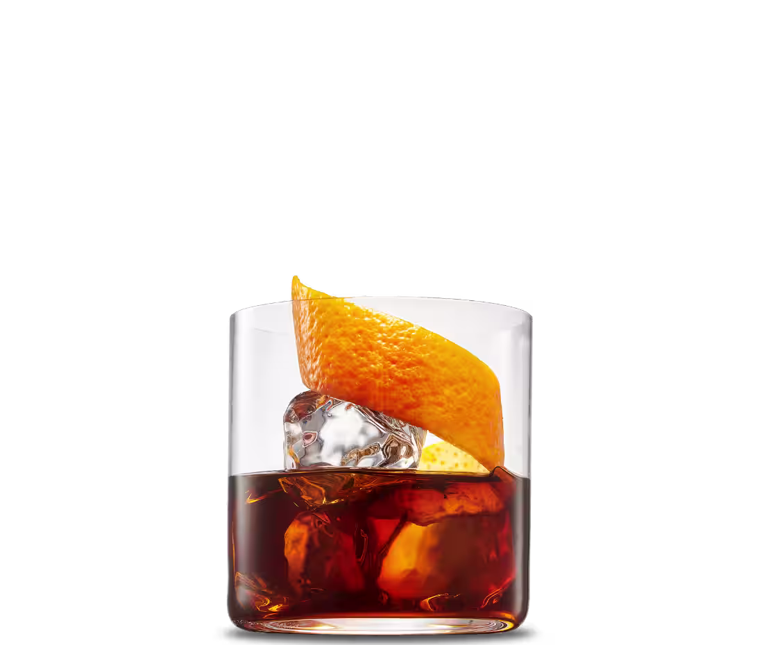 A cold brew Cold Fashioned cocktail in a rocks glass over ice with an orange peel garnish.