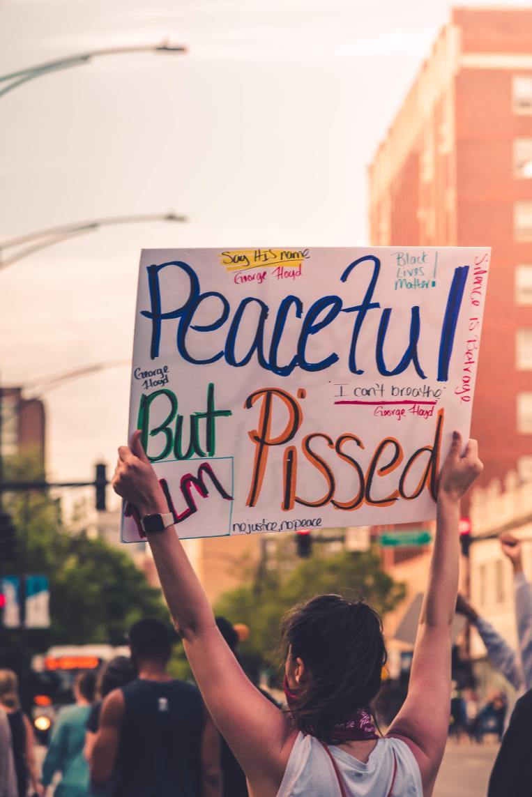 woman-holding-sign-peaceful-protest.jpg
