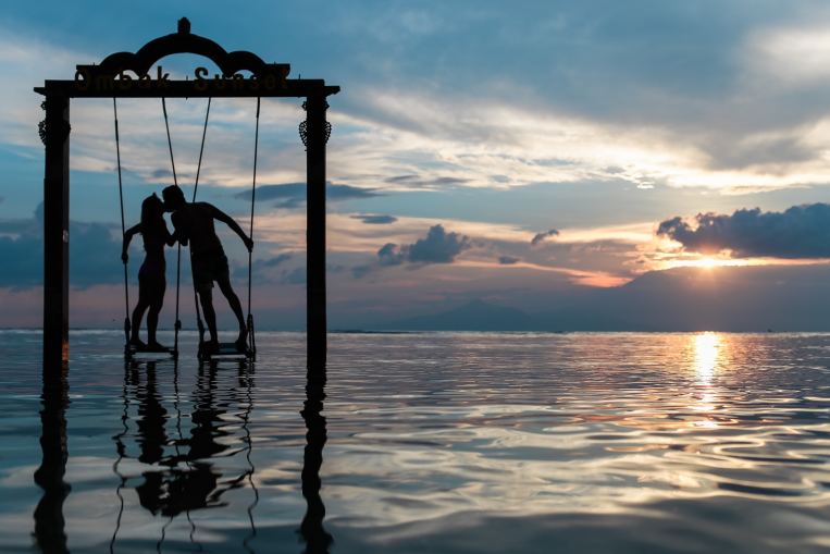 couple-water-sunset-clouds-swing.jpg